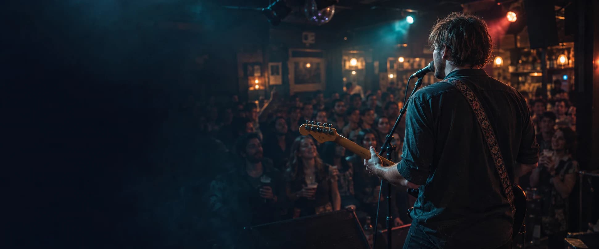 A working musician performing to a packed live venue